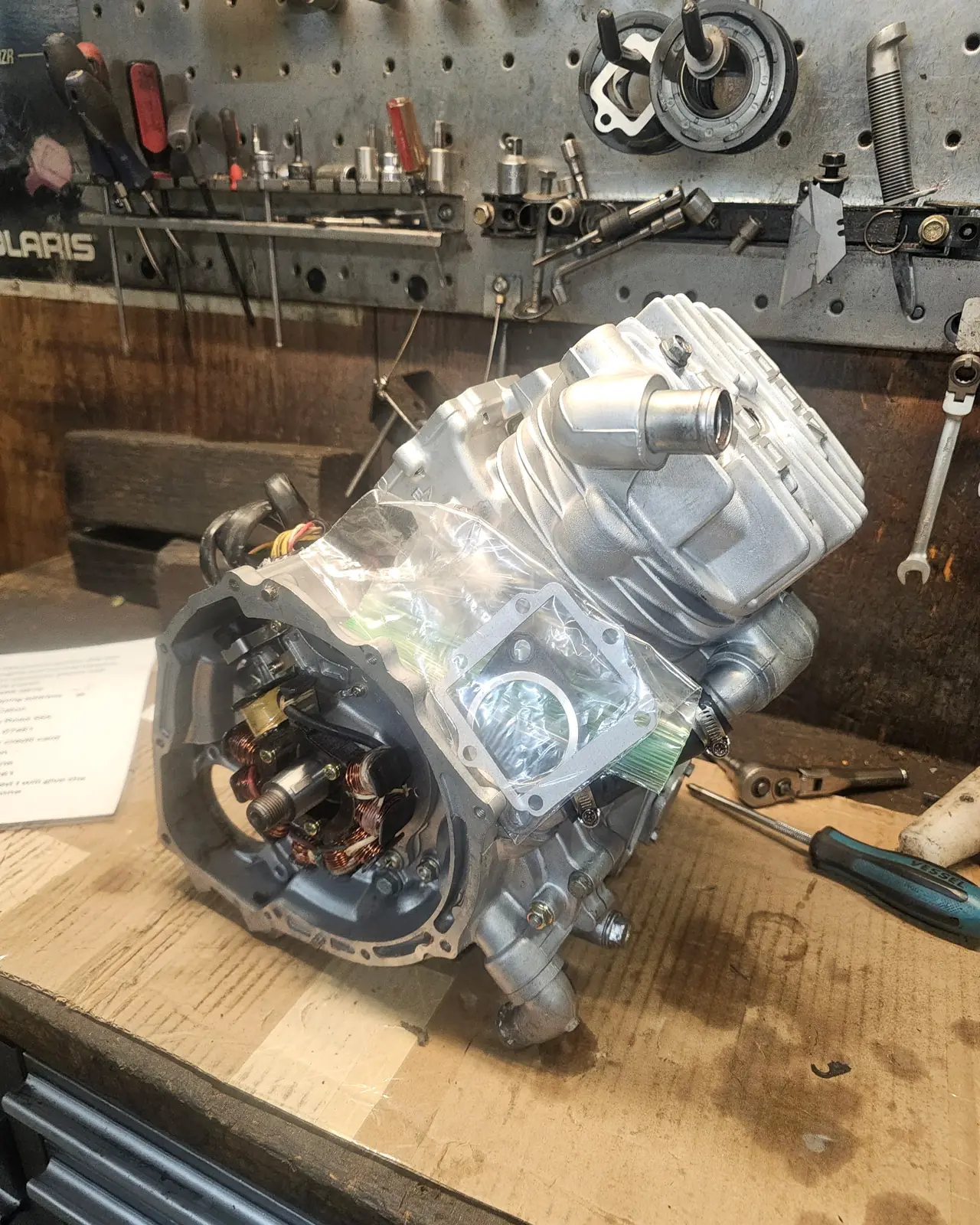 Completed Polaris 2-stroke engine rebuild on the bench with its new gaskets bagged ready to go back