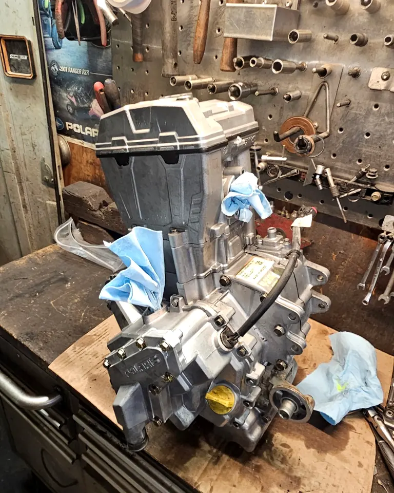 Reassembled Polaris 570 engine following a complete rebuild, standing on the workbench in the shop