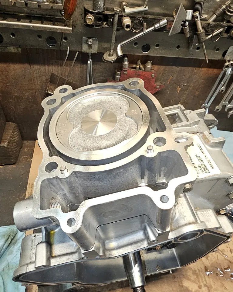 New piston and cylinder installed during a Polaris 570 rebuild, head gasket surface ready for assembly