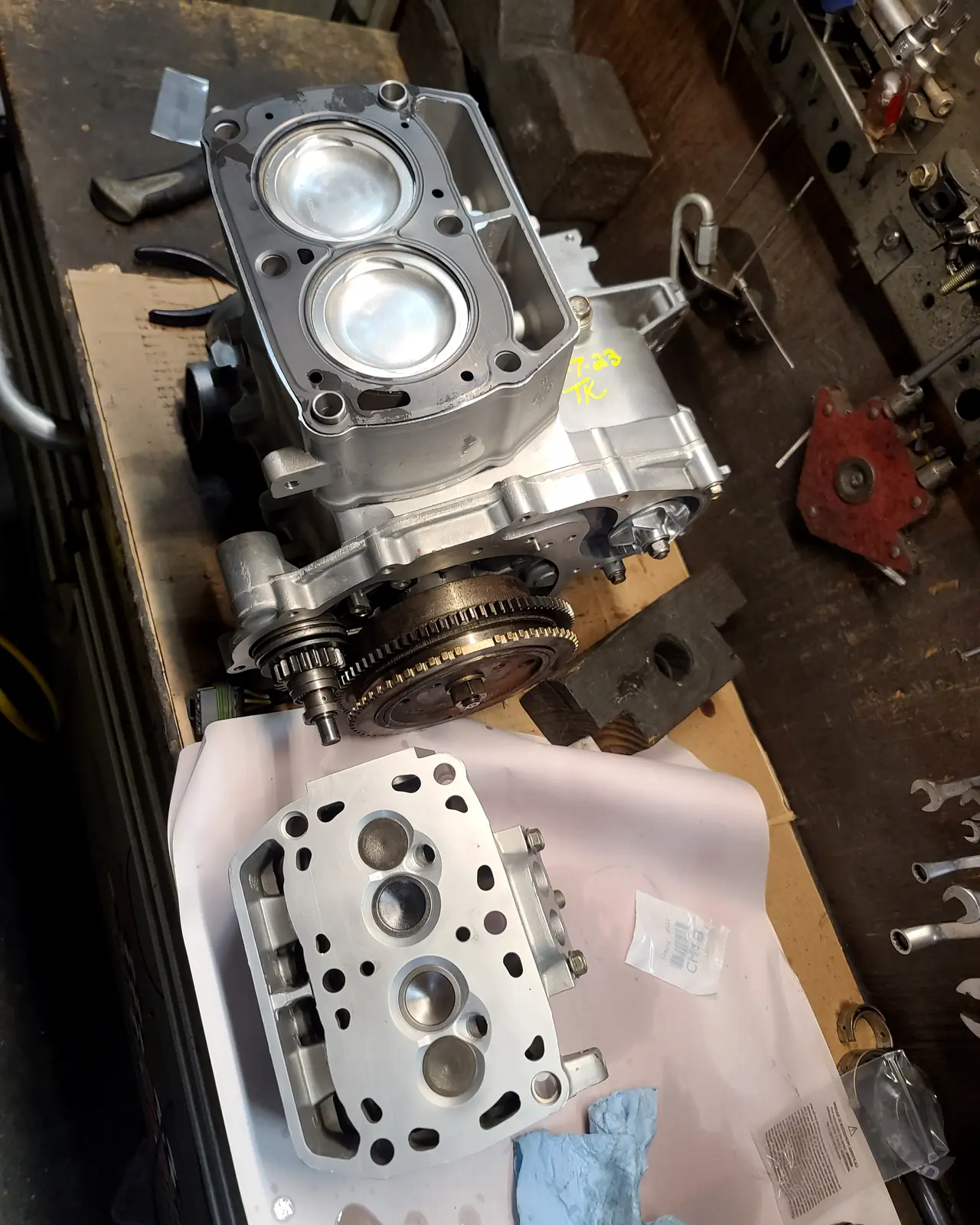 Split Polaris twin engine case with two new pistons fitted and the machined cylinder head alongside