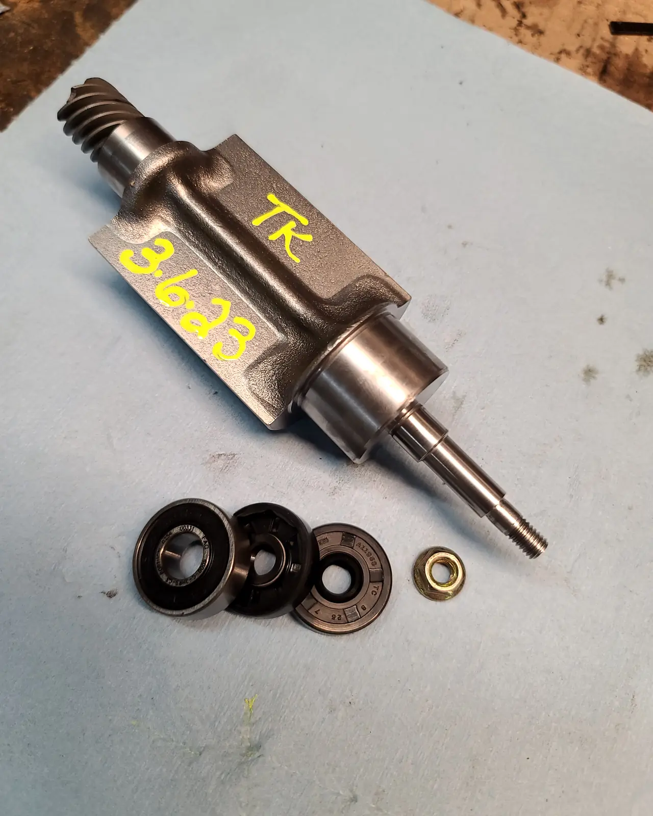 Serviced Polaris counter balance shaft laid out on the bench, marked and dated by Todd