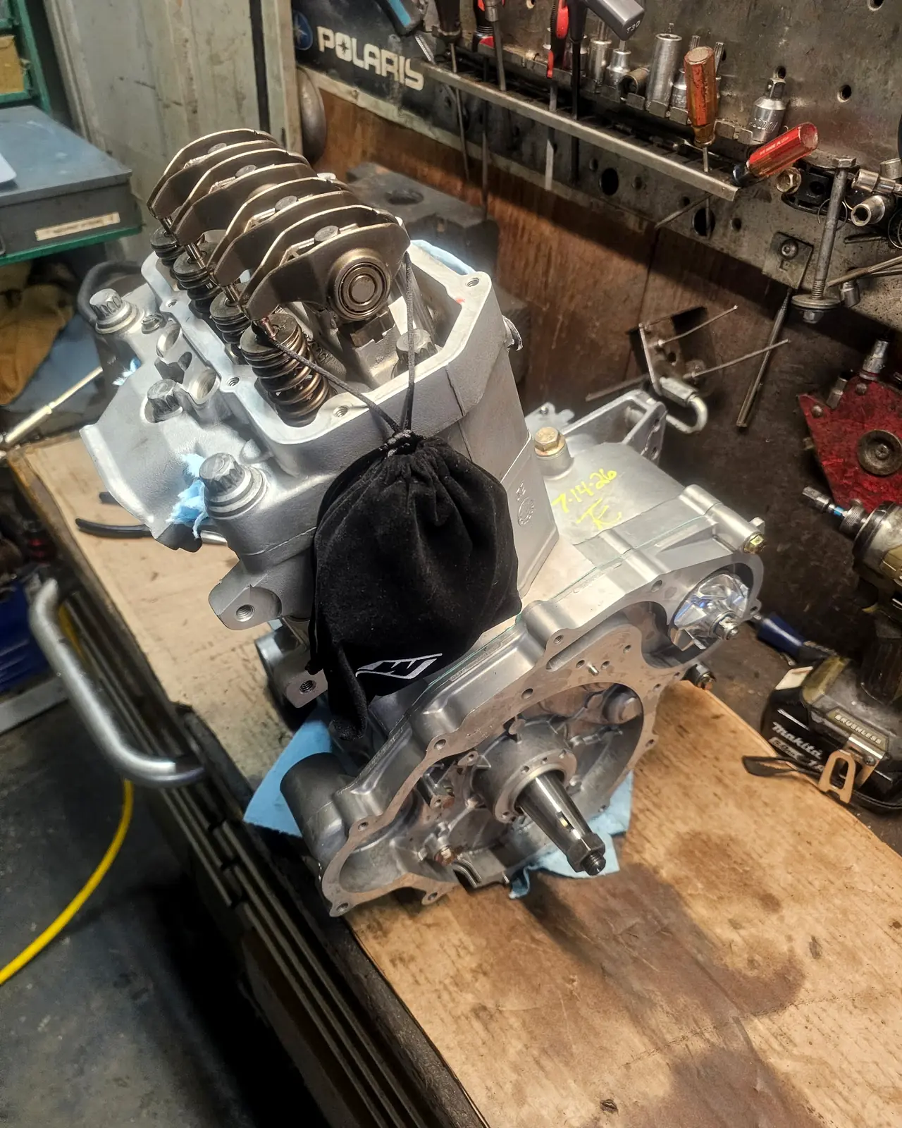 Rebuilt Polaris engine on the bench with the cylinder head open, valve springs and rockers exposed