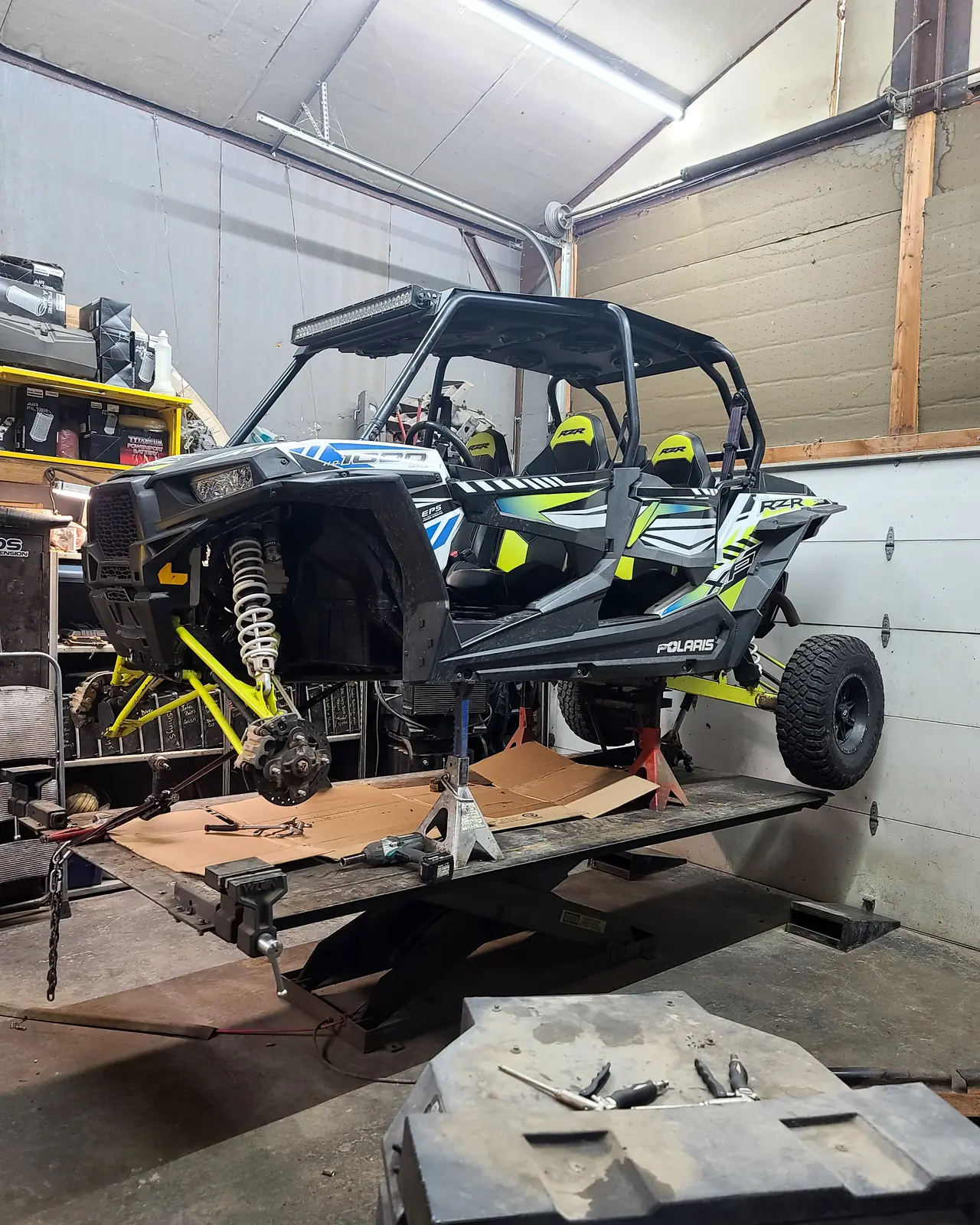 Stripped Polaris RZR chassis on the shop floor part-way through a rebuild