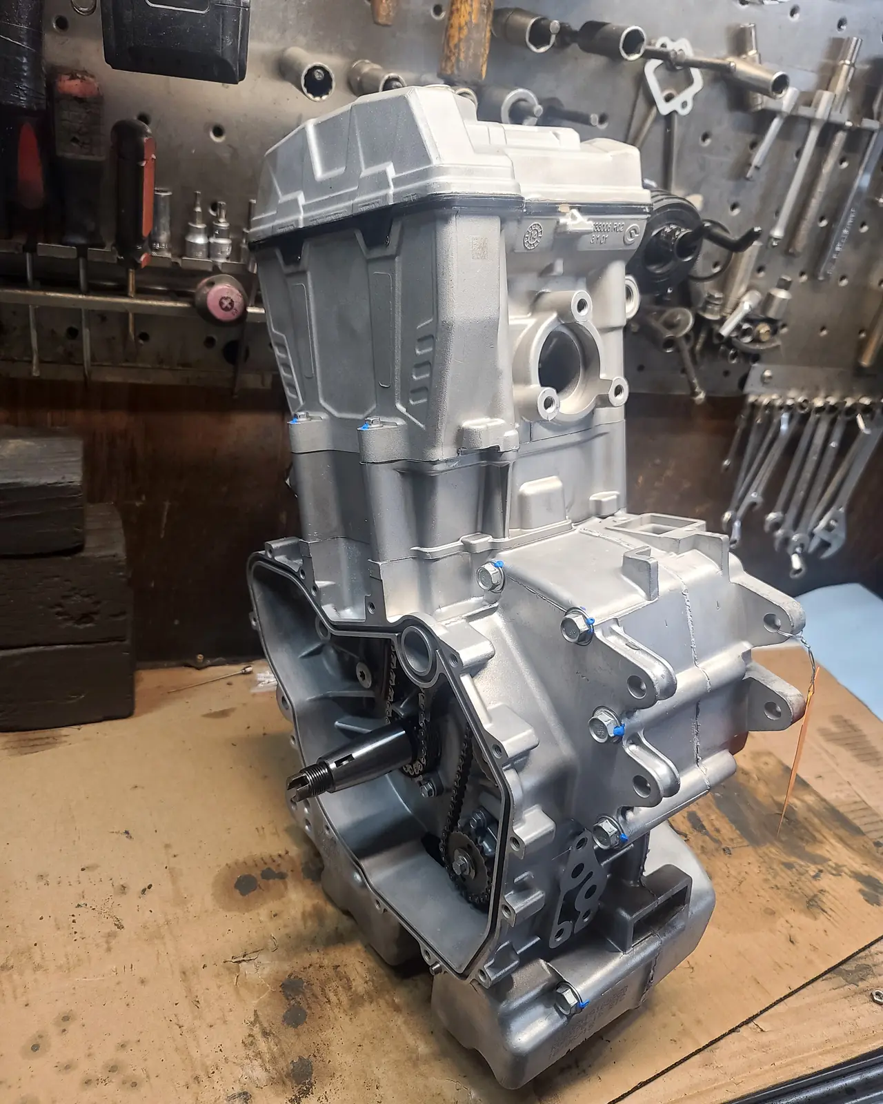 Assembled Polaris twin engine case standing on the workbench in front of the tool wall